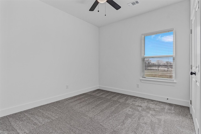 carpeted empty room featuring baseboards, visible vents, and ceiling fan