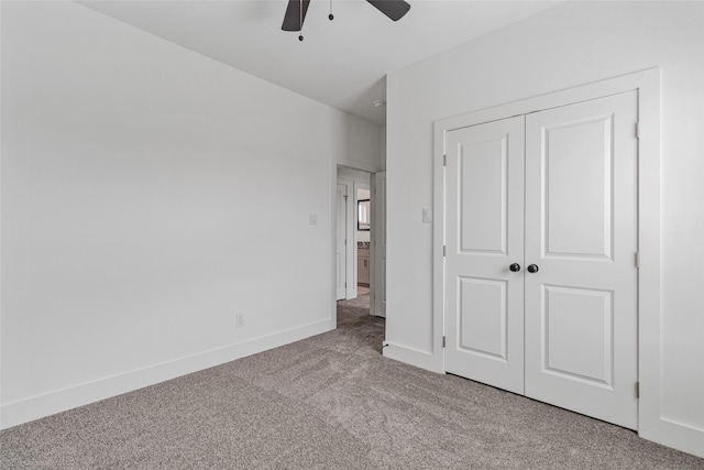 unfurnished bedroom with light carpet, a ceiling fan, baseboards, and a closet