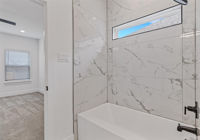 bathroom with baseboards and shower / bathing tub combination