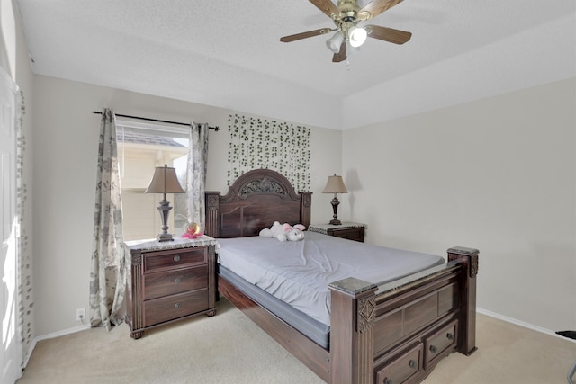 bedroom featuring light carpet, a ceiling fan, and baseboards