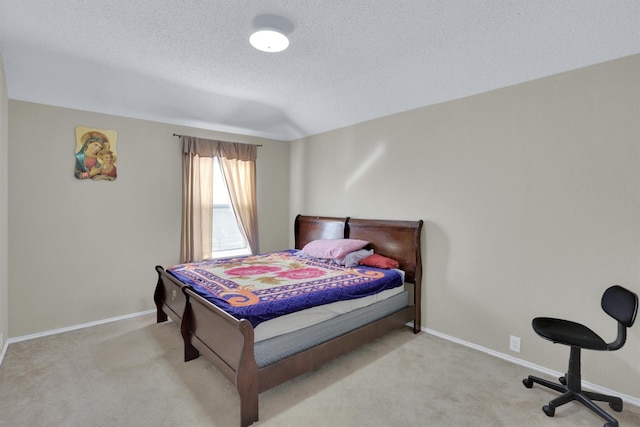 carpeted bedroom with baseboards and a textured ceiling