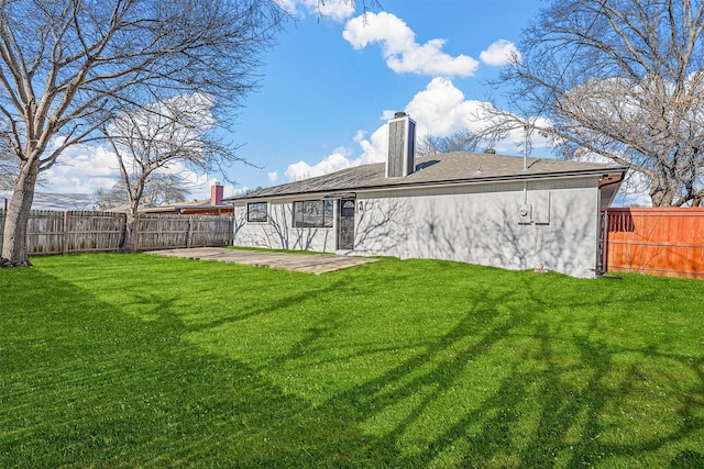 view of yard featuring a patio area and a fenced backyard