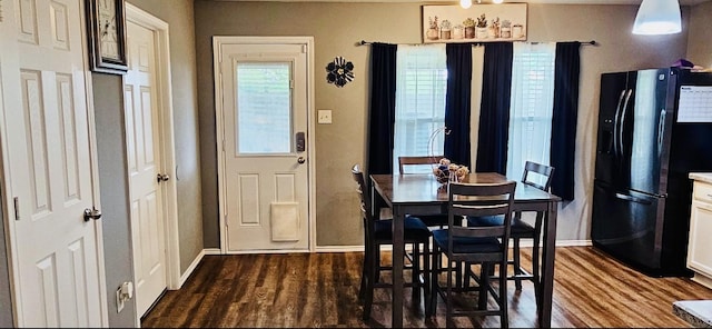 dining room with baseboards and dark wood finished floors