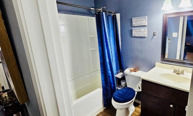full bath featuring a textured wall, shower / tub combo, toilet, and vanity