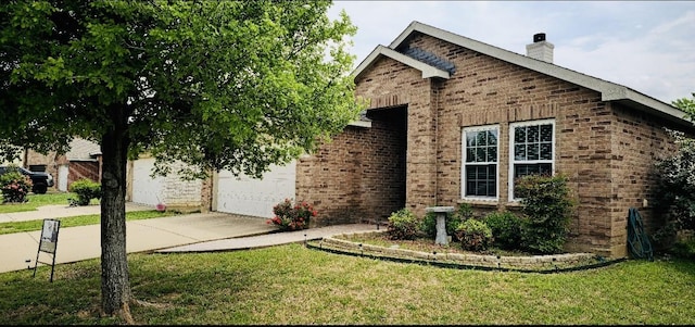 view of front facade featuring a chimney, a front lawn, concrete driveway, an attached garage, and brick siding