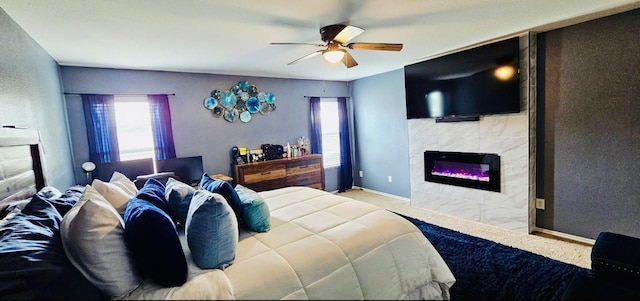 carpeted bedroom with a tile fireplace, baseboards, and ceiling fan