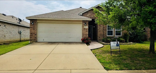 view of front of house featuring concrete driveway, brick siding, a front yard, and a garage