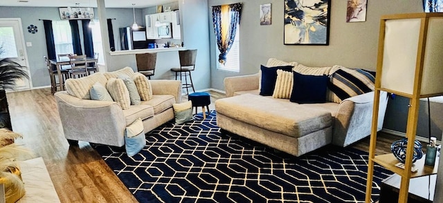 living area with wood finished floors and baseboards