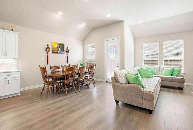 dining space with recessed lighting, vaulted ceiling, light wood-style flooring, and baseboards