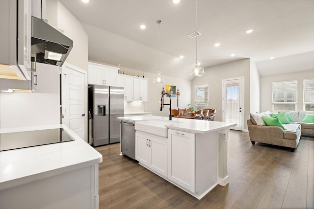 kitchen with visible vents, appliances with stainless steel finishes, light countertops, under cabinet range hood, and a sink