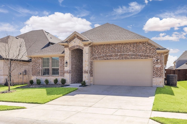 french country style house featuring concrete driveway, brick siding, a front lawn, and an attached garage