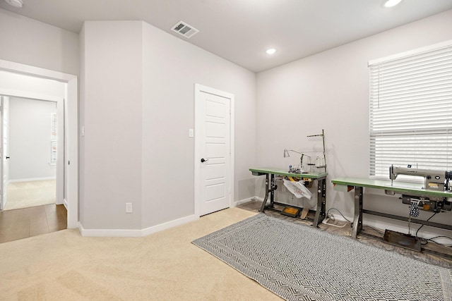 carpeted office space featuring baseboards, visible vents, and recessed lighting