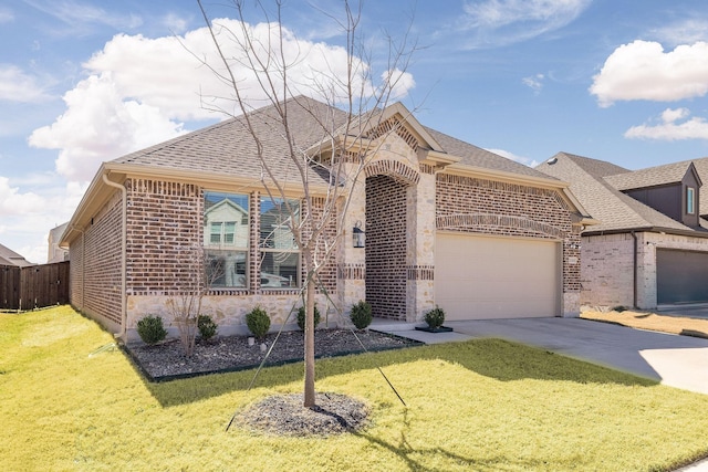 view of front of property with brick siding, concrete driveway, stone siding, an attached garage, and a front yard