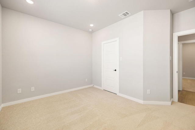 spare room featuring carpet, visible vents, and recessed lighting