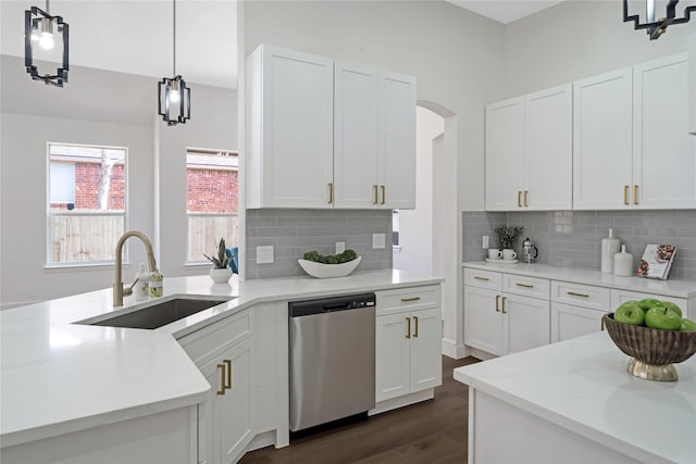 kitchen featuring dishwasher, dark wood-style flooring, a sink, and white cabinets