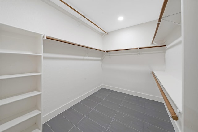 spacious closet with dark tile patterned floors