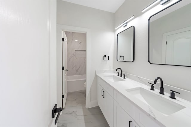 full bath featuring shower / washtub combination, marble finish floor, a sink, and double vanity