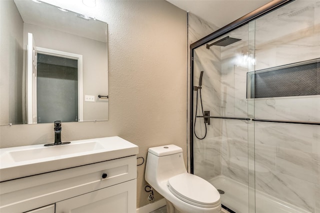 bathroom featuring toilet, a stall shower, a textured wall, and vanity