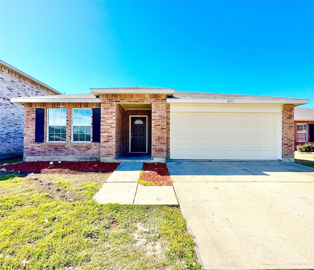 view of front of property featuring a garage, concrete driveway, and brick siding