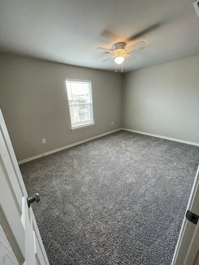 unfurnished room with carpet floors, baseboards, and a ceiling fan