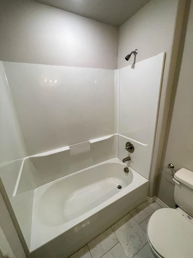 bathroom with washtub / shower combination and toilet