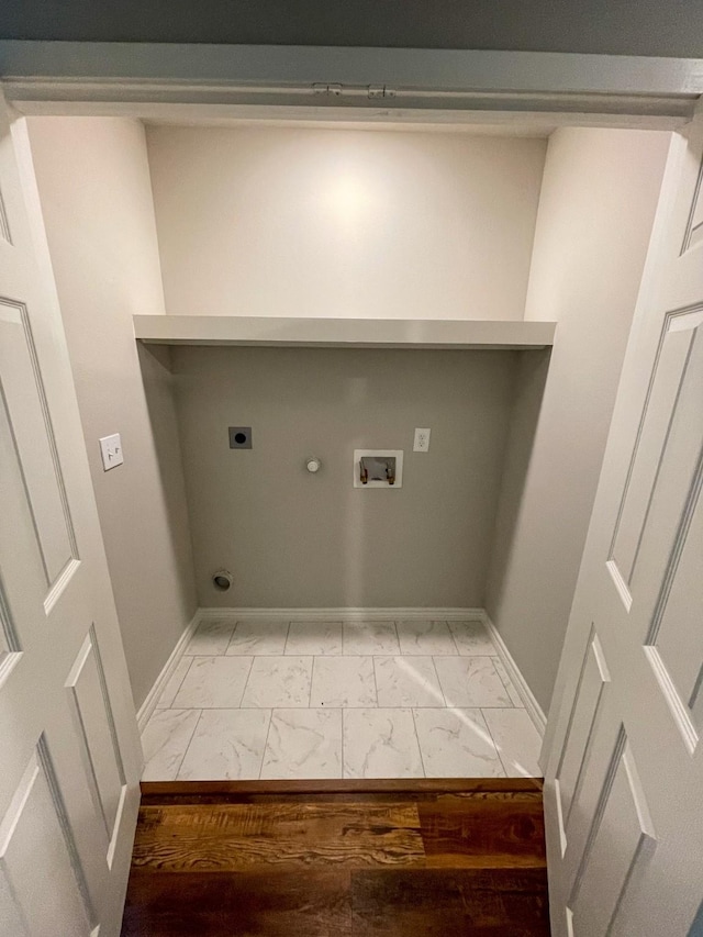 clothes washing area with marble finish floor, hookup for a washing machine, gas dryer hookup, electric dryer hookup, and baseboards