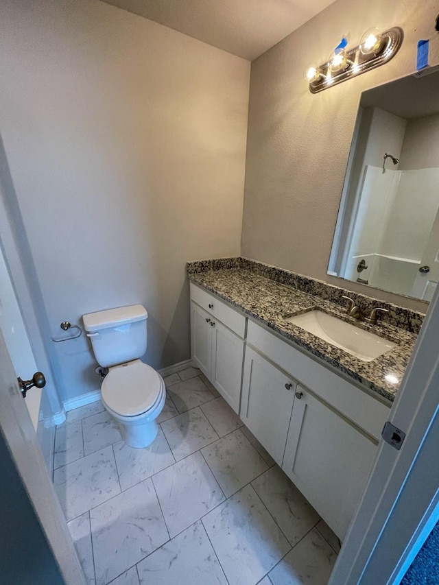 bathroom featuring baseboards, toilet, marble finish floor, walk in shower, and vanity