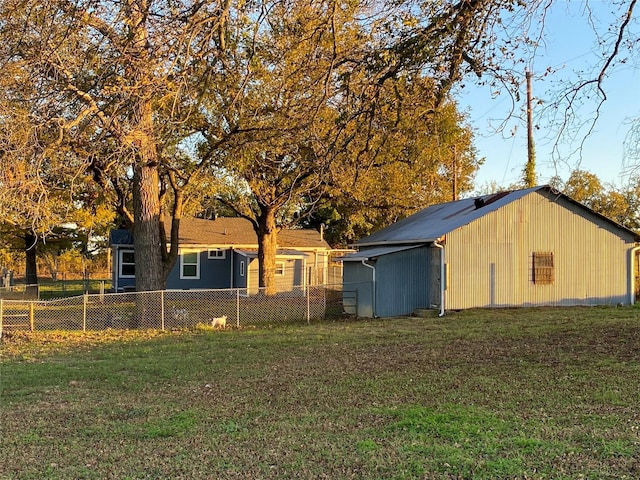 view of yard with an outbuilding, a pole building, and fence