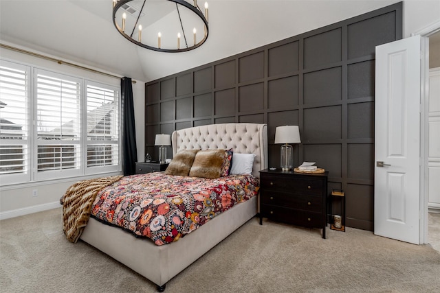 carpeted bedroom with lofted ceiling, a decorative wall, baseboards, and an inviting chandelier