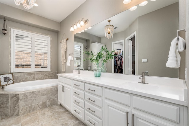 bathroom with visible vents, double vanity, a sink, and a bath