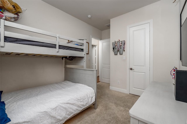 bedroom with light carpet, visible vents, and baseboards