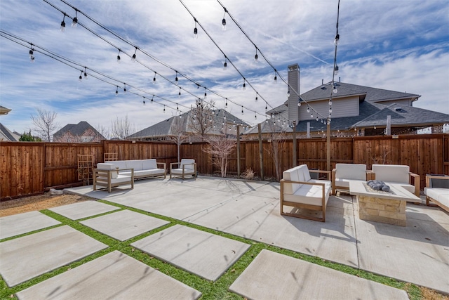 view of patio / terrace featuring a fenced backyard and an outdoor living space with a fire pit