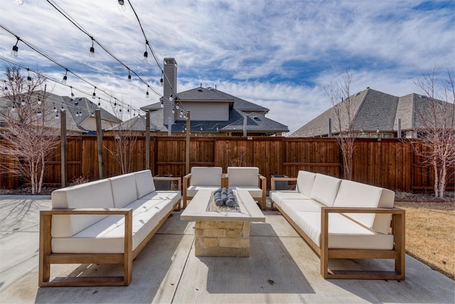 view of patio with a fenced backyard and an outdoor living space with a fire pit