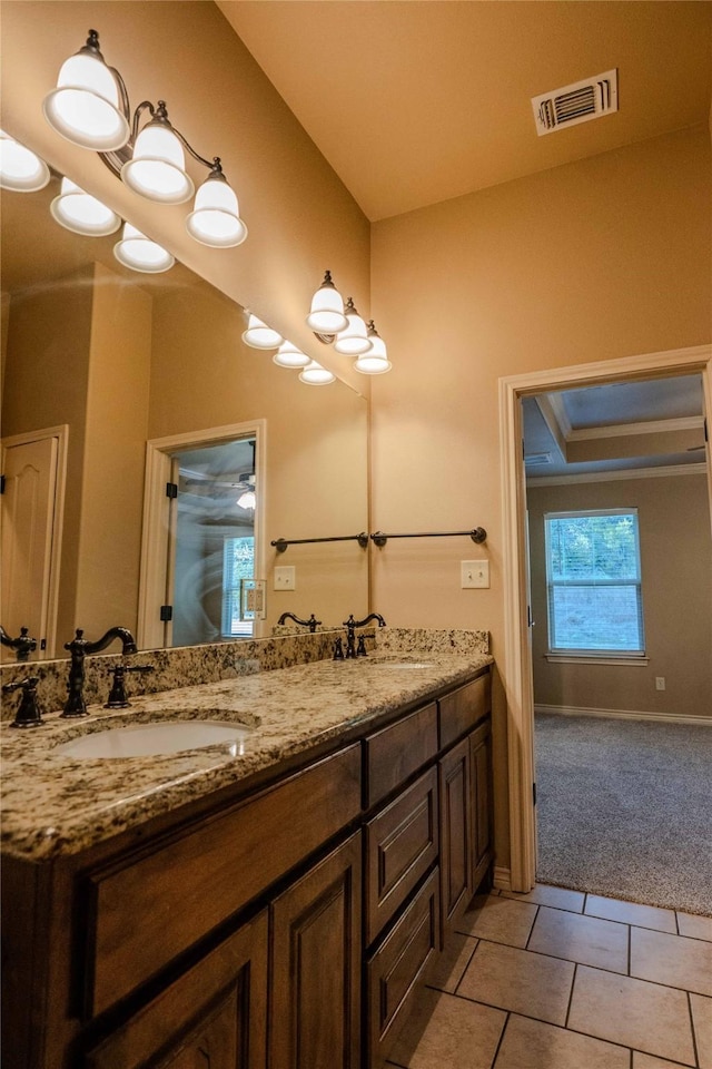 full bathroom with double vanity, tile patterned flooring, a sink, and visible vents