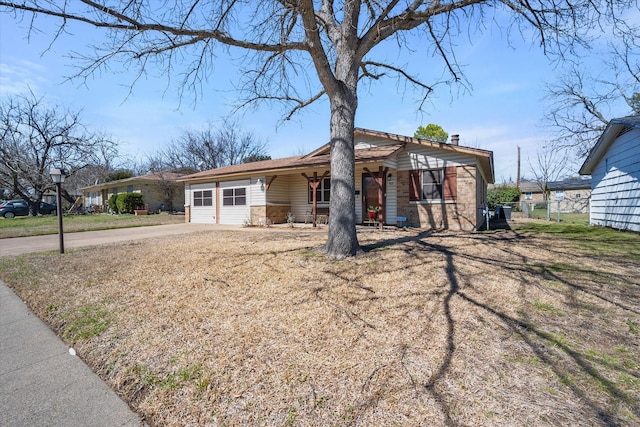 view of front facade with driveway, a garage, and brick siding