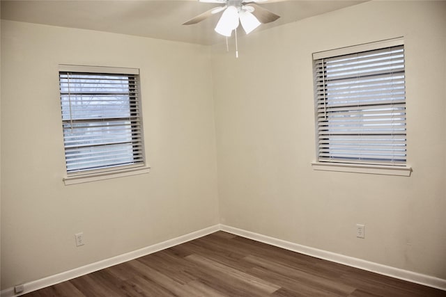 empty room with dark wood-type flooring, ceiling fan, and baseboards