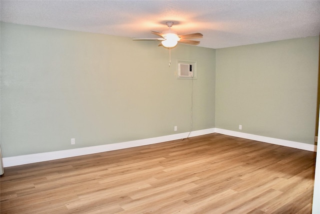 unfurnished room with baseboards, ceiling fan, a textured ceiling, and light wood finished floors