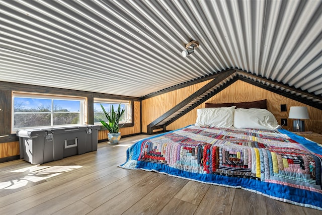 bedroom with light wood-style flooring and metal wall