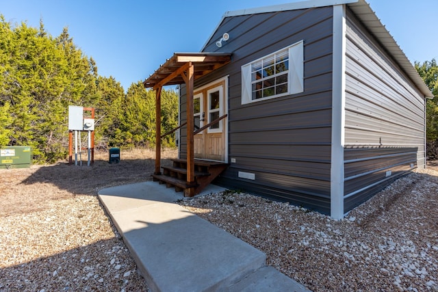 view of property exterior with entry steps and crawl space