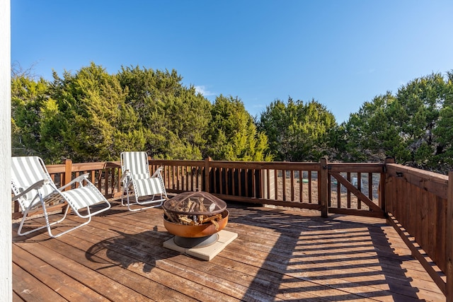 wooden terrace with an outdoor fire pit