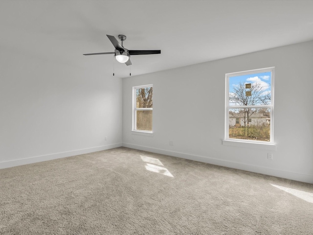 spare room featuring carpet floors, baseboards, and a ceiling fan