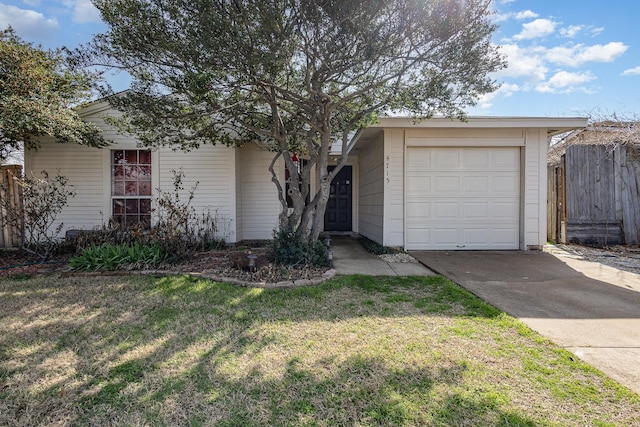 view of front facade featuring driveway, a front yard, and fence