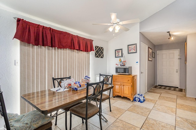 dining space with lofted ceiling and a ceiling fan