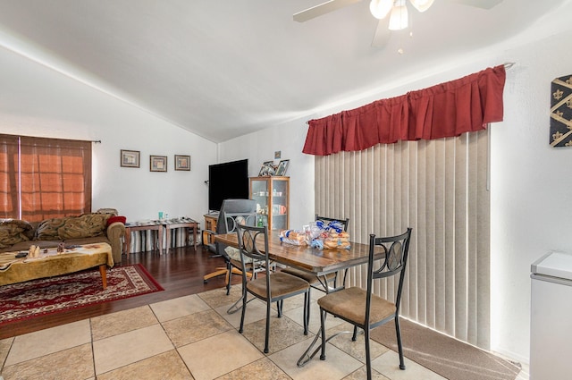 dining room with lofted ceiling, a ceiling fan, and light tile patterned flooring