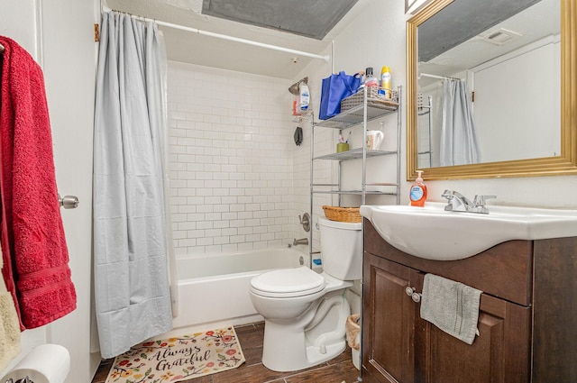 bathroom featuring visible vents, toilet, shower / bath combo with shower curtain, vanity, and wood finished floors