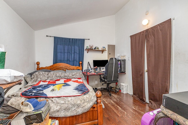 bedroom featuring lofted ceiling and wood finished floors