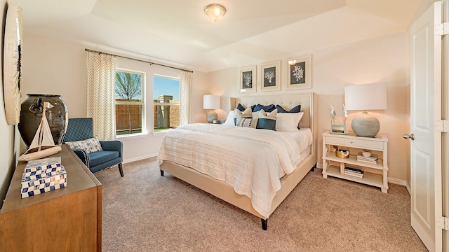 bedroom featuring baseboards and light colored carpet