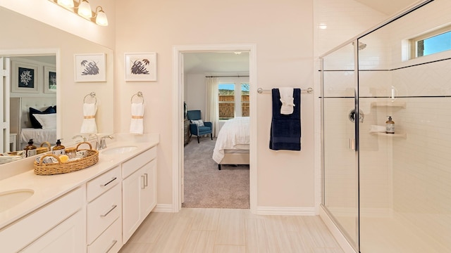 ensuite bathroom with double vanity, a shower stall, a sink, and ensuite bathroom