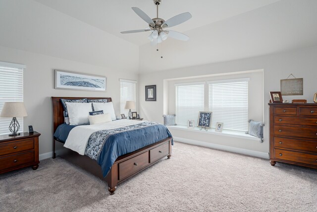 carpeted bedroom featuring a ceiling fan, lofted ceiling, and baseboards