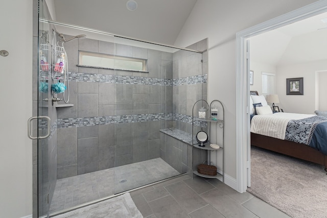 full bath featuring ensuite bath, tile patterned floors, lofted ceiling, and tiled shower